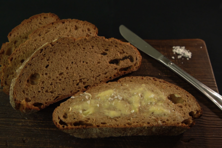 Mehrere Brotscheiben, eine mit aufgestrichener Butter | © Land schafft Leben